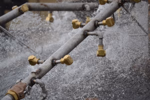 Water spray bars cooling the surface of a steelmaking furnace.