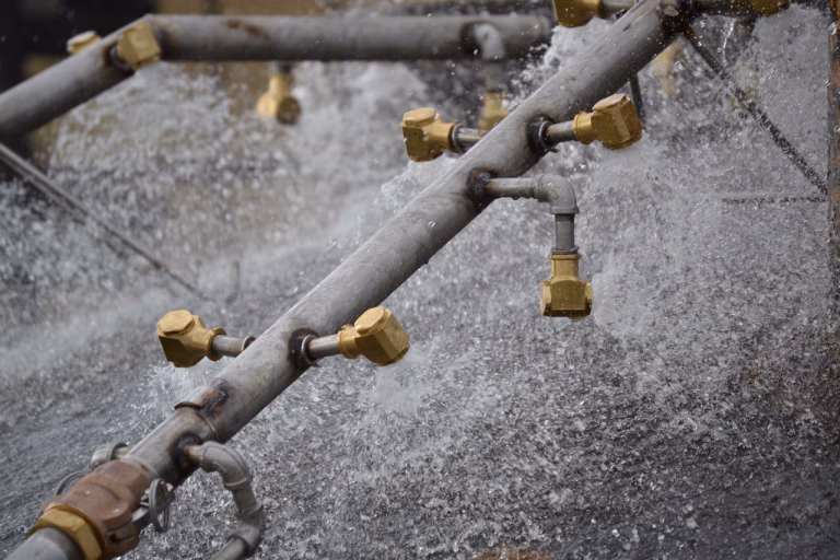 Water spray bars cooling the surface of a steelmaking furnace.