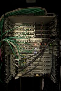 Physical server racks with mounted equipment and network cables.