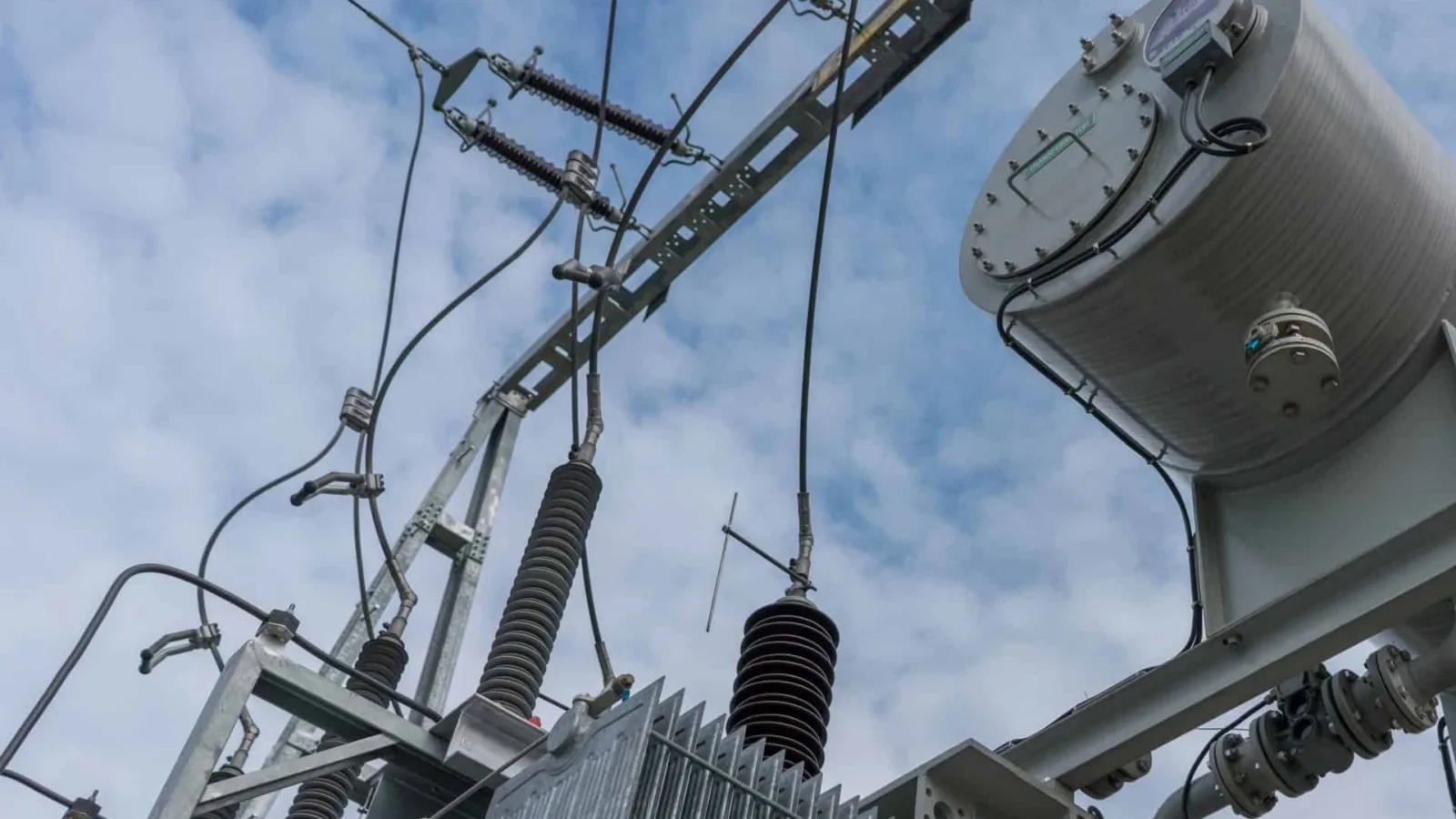 High-voltage bushings and conservator of a power transformer against the sky